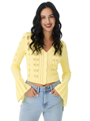 Woman wearing a yellow cardigan with butterfly details on a white background